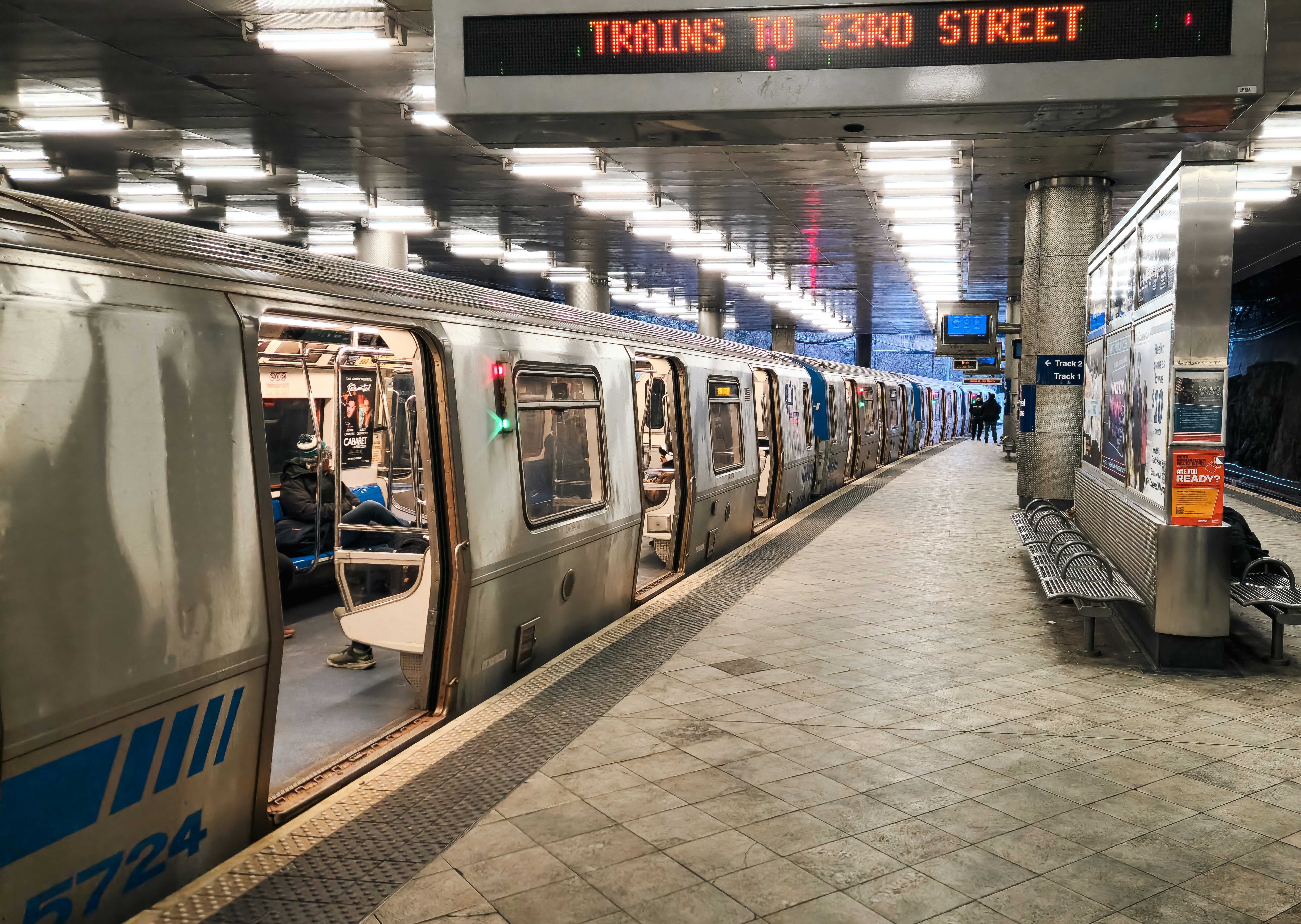 PATH train platform at Journal Square station with sign reading Trains to 33rd Street