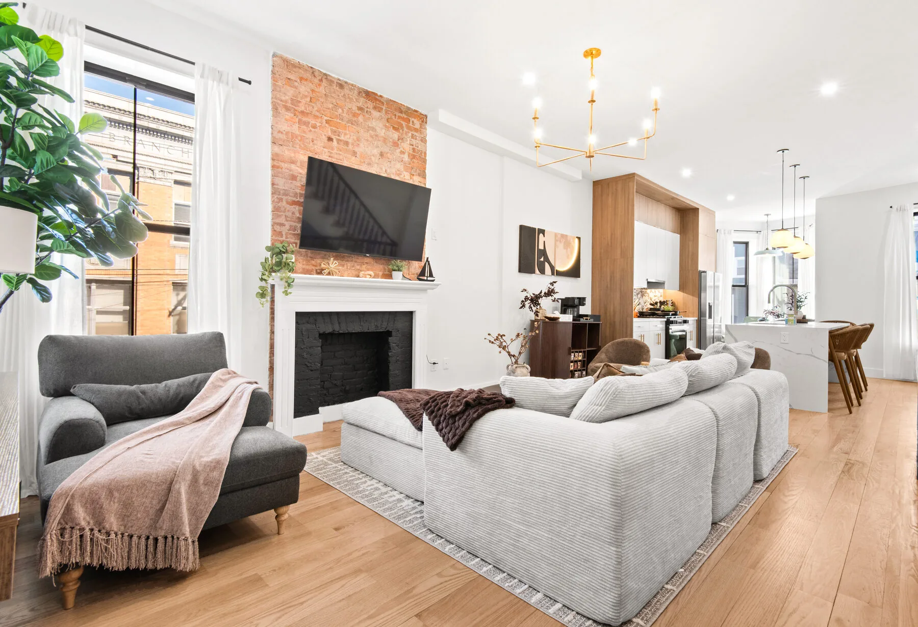 Main living area with exposed brick fireplace