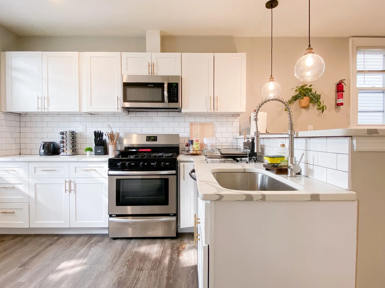 Full kitchen — star island, exposed brick, stainless appliances