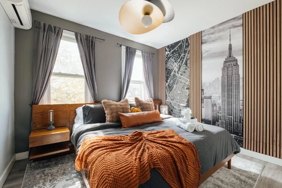 NYC skyline mural bedroom with wood slat accent wall