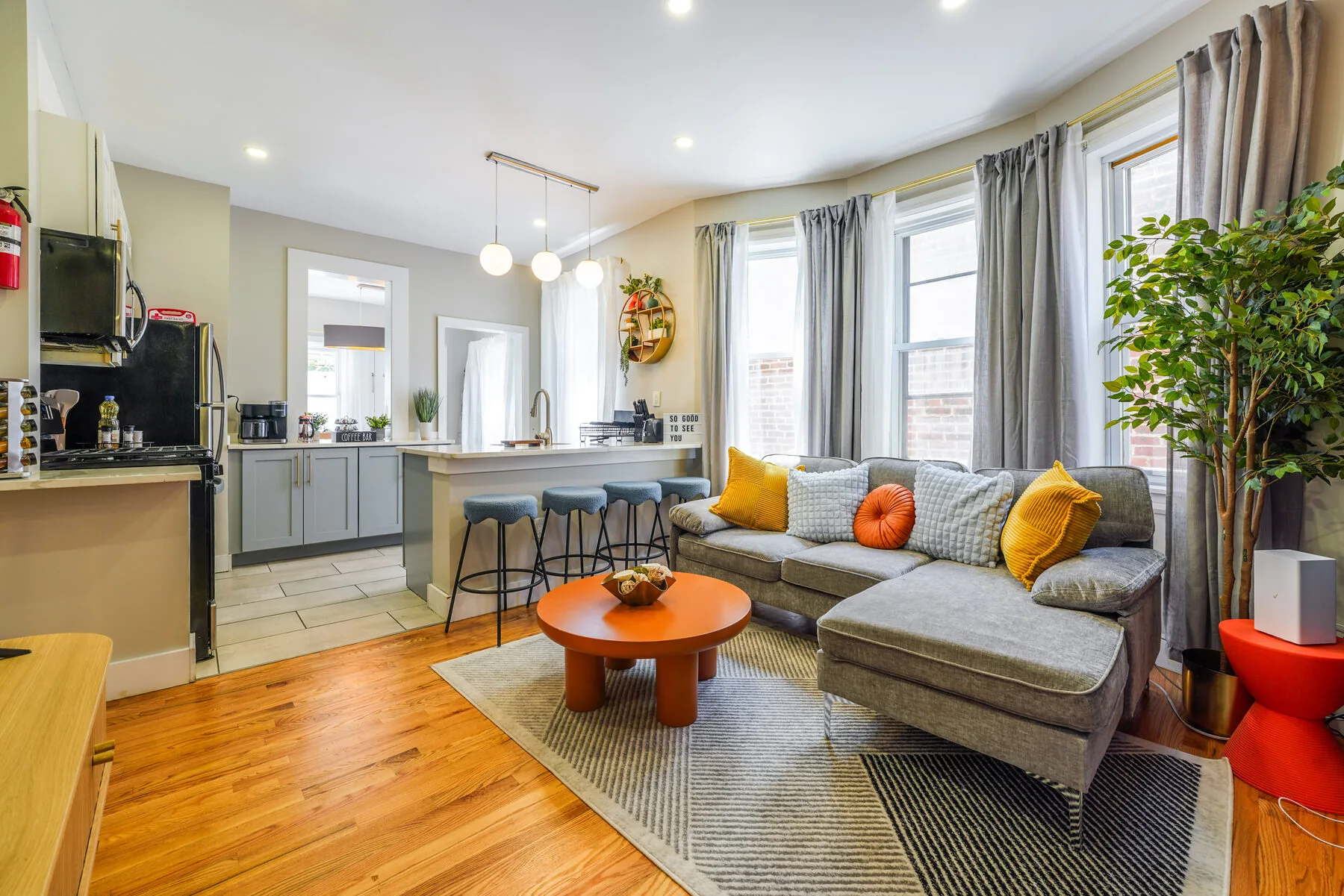 Open living and kitchen area with warm hardwood floors
