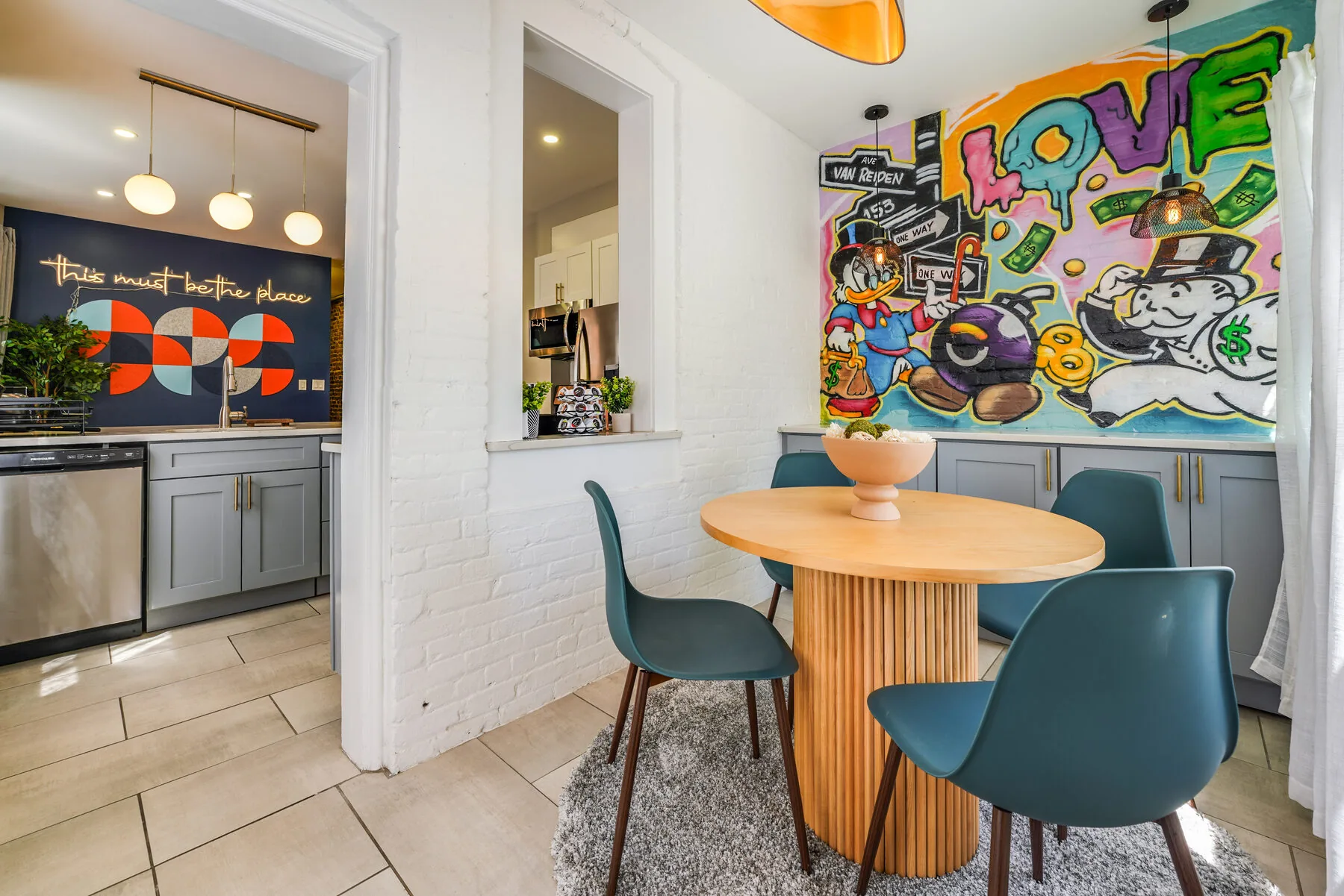 Sunroom dining area with graffiti mural