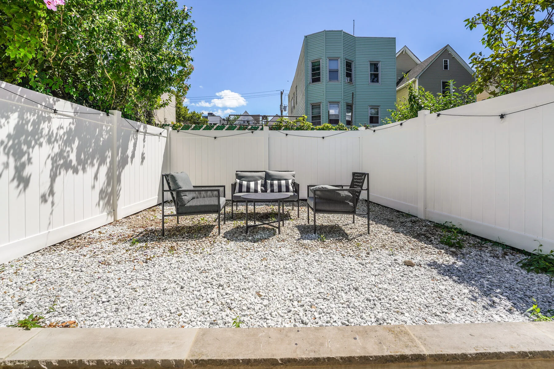 Private enclosed backyard with seating
