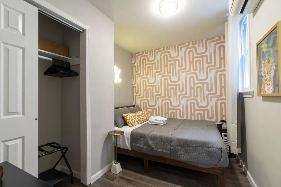Second bedroom with terracotta maze wallpaper