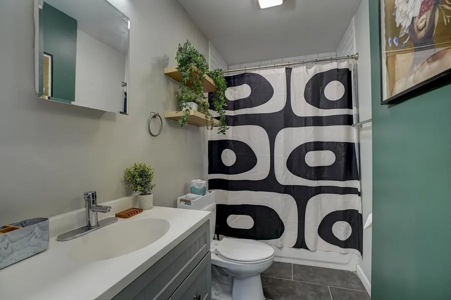 Bathroom with bold mod black and white shower curtain