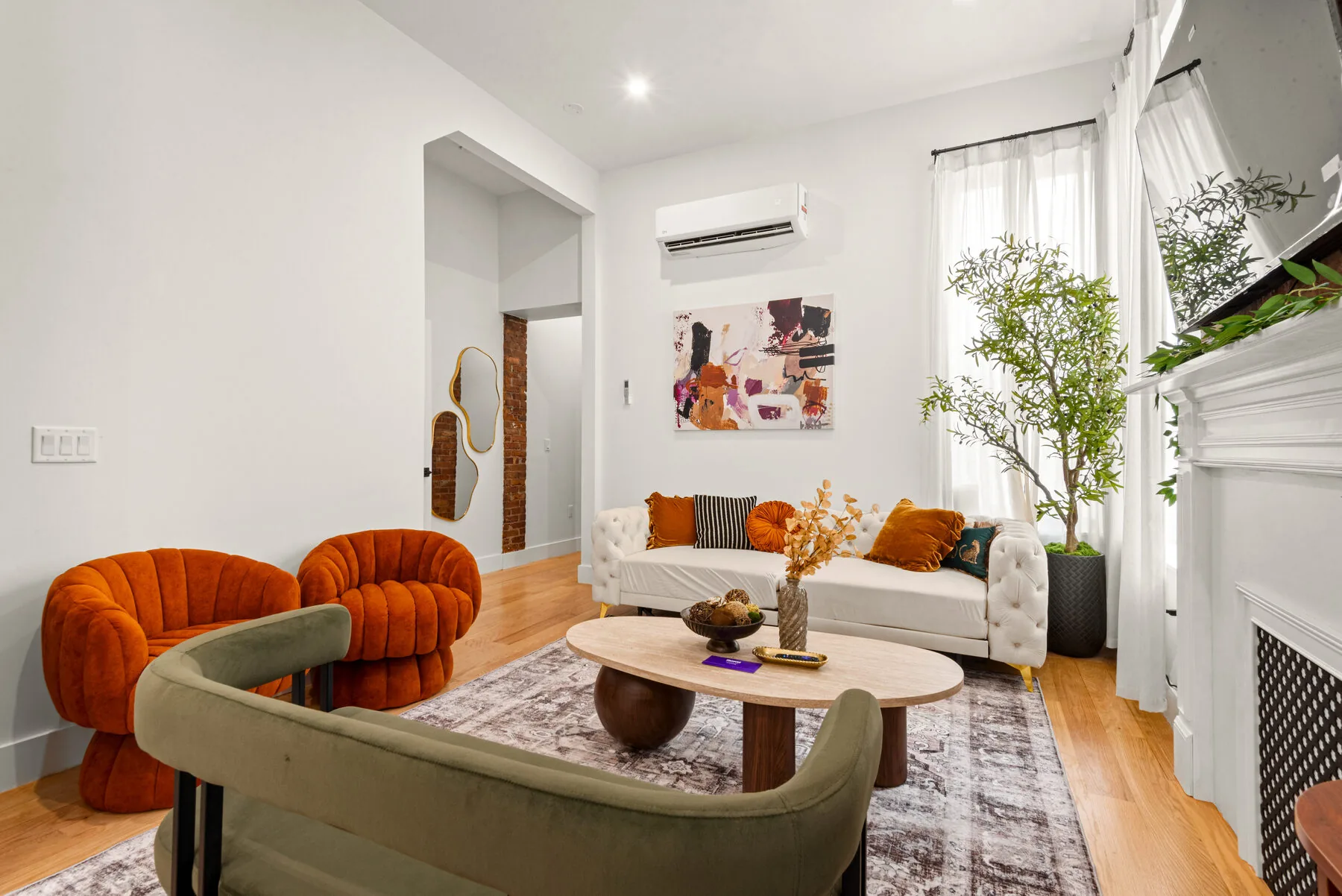 Main living area with orange velvet chairs