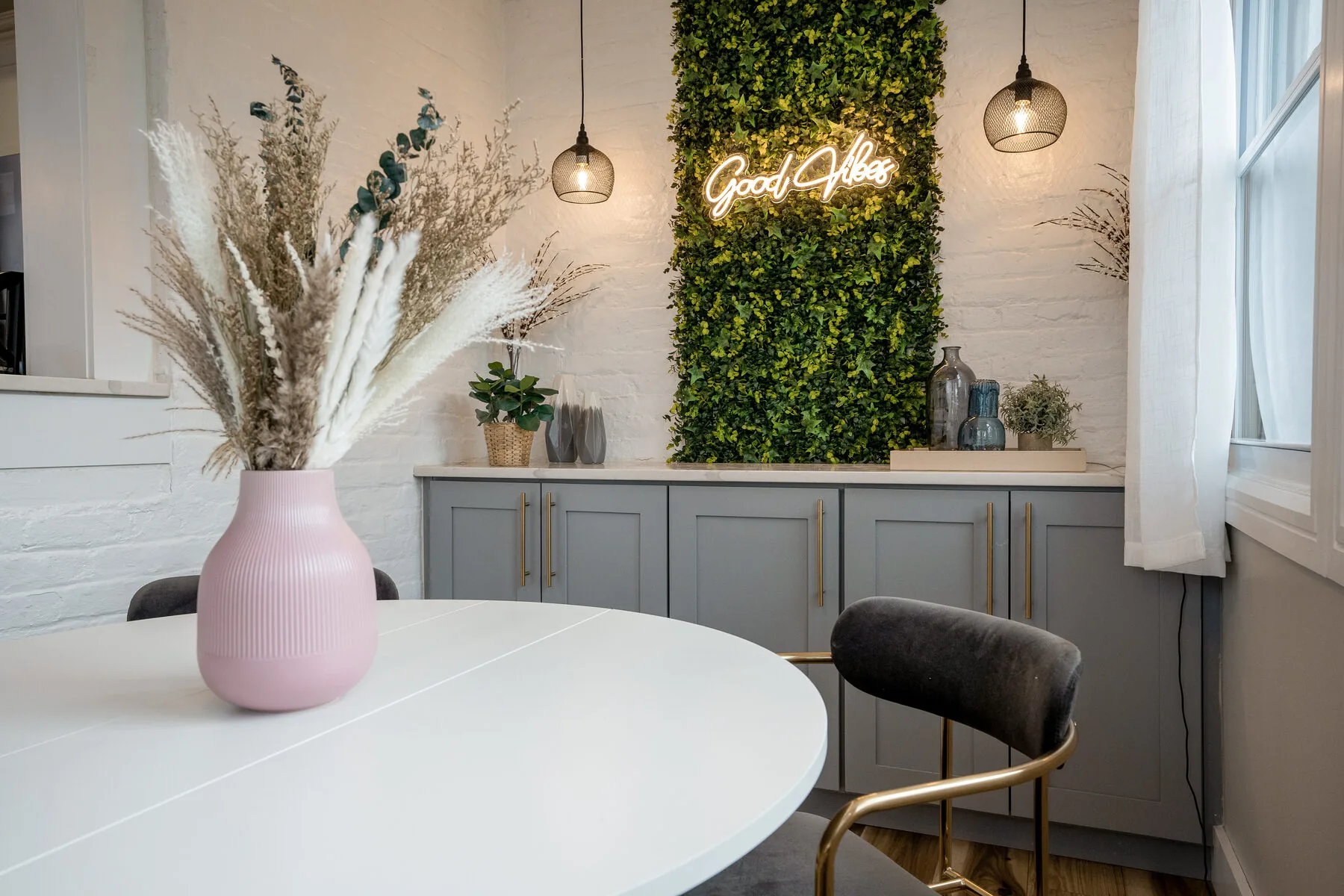 Sunroom with Good Vibes neon and living wall