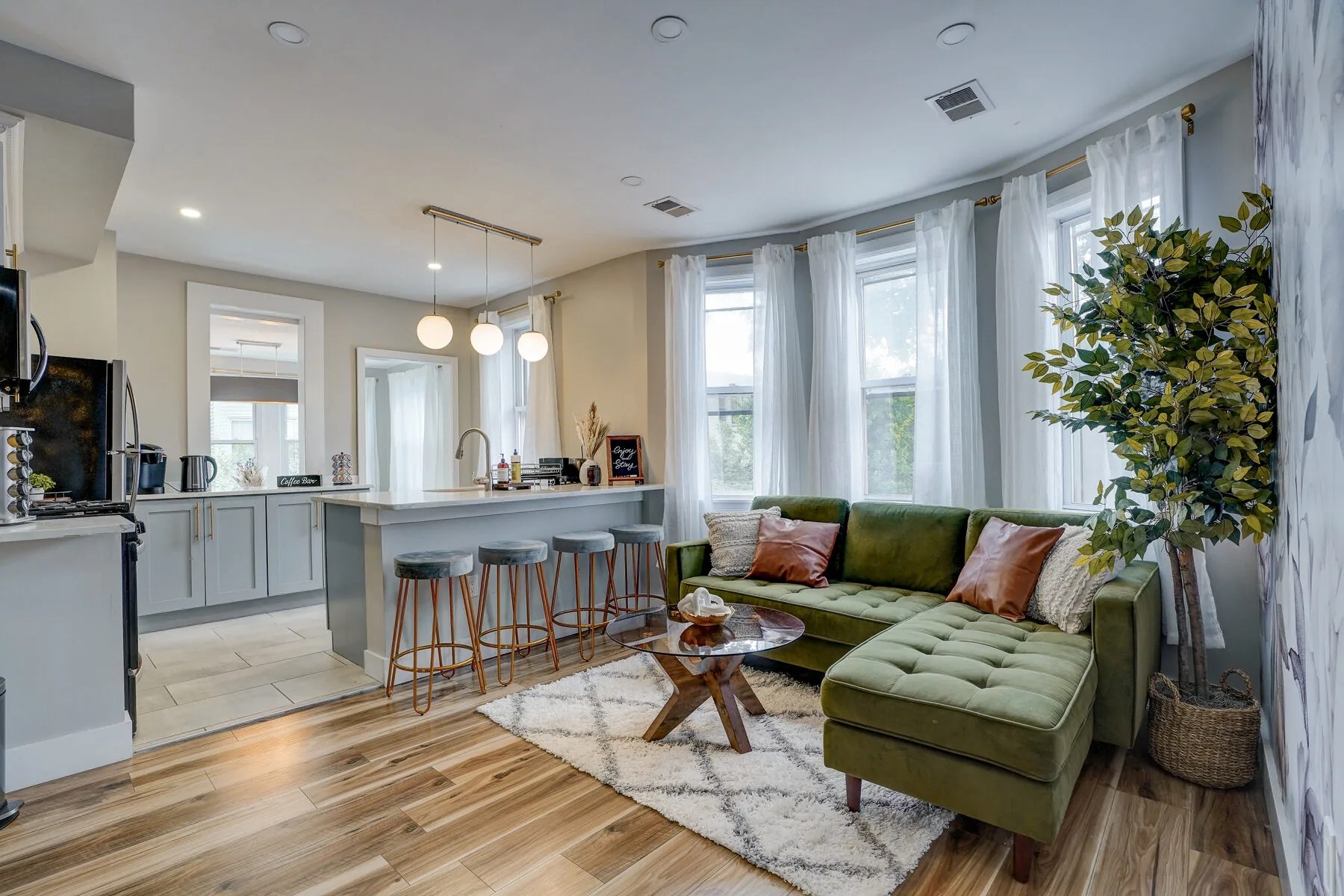 SunSuite living room with green couch